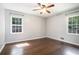 Bedroom with hardwood floors, two windows, and neutral wall paint at 1663 Pounds Sw Rd, Stone Mountain, GA 30087