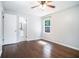 Bright bedroom features hardwood floors, a ceiling fan and a view to the bathroom at 1663 Pounds Sw Rd, Stone Mountain, GA 30087