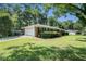 Charming single story brick home with green lawn, and a two car garage in a wooded area at 1663 Pounds Sw Rd, Stone Mountain, GA 30087