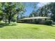Charming brick home with a well-manicured front lawn and mature trees at 1663 Pounds Sw Rd, Stone Mountain, GA 30087