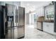 Updated kitchen featuring stainless appliances, tile backsplash, and a spacious refrigerator at 1663 Pounds Sw Rd, Stone Mountain, GA 30087