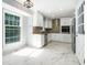 Bright updated kitchen features new appliances, tile flooring, and a stylish backsplash at 1663 Pounds Sw Rd, Stone Mountain, GA 30087