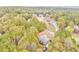 Aerial view of homes nestled among vibrant autumn foliage in a wooded neighborhood at 408 Gray Fox Dr, Canton, GA 30114