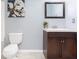 Bathroom features a modern vanity with a framed mirror and tiled floors at 408 Gray Fox Dr, Canton, GA 30114