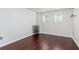 Bright bedroom features hardwood floors, two windows, and a large blank wall ready for decor at 408 Gray Fox Dr, Canton, GA 30114