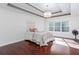 Bedroom features hardwood floors, ceiling fan, tray ceilings, and a cozy bed at 408 Gray Fox Dr, Canton, GA 30114