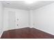 A clean bedroom has neutral walls, a white door, and hardwood floors, ideal for relaxing at 408 Gray Fox Dr, Canton, GA 30114