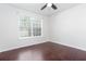 This bright bedroom has hardwood floors, a modern ceiling fan, and a large window at 408 Gray Fox Dr, Canton, GA 30114