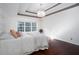 Bedroom features hardwood floors, tray ceilings, ceiling fan, and a large window at 408 Gray Fox Dr, Canton, GA 30114