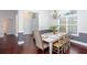 Dining room with hardwood floors, stylish chairs, large window, and open view to foyer and front door at 408 Gray Fox Dr, Canton, GA 30114