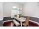 Formal dining area with wainscoting, chandelier, and a large window providing natural light and an elegant setting at 408 Gray Fox Dr, Canton, GA 30114