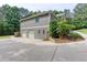 Large home with attached garage and driveway surrounded by lush greenery at 408 Gray Fox Dr, Canton, GA 30114