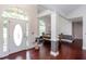 Inviting foyer showcasing hardwood floors, high ceilings, elegant columns, and an arched window above the door at 408 Gray Fox Dr, Canton, GA 30114