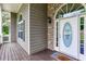 Close-up of the front entrance featuring a decorative glass door, stone accents, and a covered porch area at 408 Gray Fox Dr, Canton, GA 30114