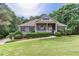 Charming single-story home with a manicured lawn and mature landscaping creating an inviting curb appeal at 408 Gray Fox Dr, Canton, GA 30114