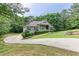 Long driveway leading to a well-maintained single-story home with mature trees in a quiet neighborhood setting at 408 Gray Fox Dr, Canton, GA 30114