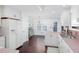 Open kitchen boasts white cabinets, hardwood floors, and adjacent dining area at 408 Gray Fox Dr, Canton, GA 30114