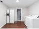 Laundry room featuring luxury vinyl plank flooring, washer, dryer, and modern refrigerator at 408 Gray Fox Dr, Canton, GA 30114