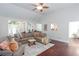 Bright living room featuring hardwood floors, vaulted ceiling, and comfortable sectional sofa at 408 Gray Fox Dr, Canton, GA 30114