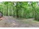 Expansive property featuring a wooded area and gravel driveway at 408 Gray Fox Dr, Canton, GA 30114