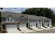 New construction townhomes featuring attached garages and modern color scheme with sidewalks at 5004 Elowen Ln, Douglasville, GA 30135