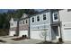 New townhome exterior featuring attached garages and modern gray color scheme with many windows at 5004 Elowen Ln, Douglasville, GA 30135