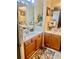 Bathroom with double sinks, framed mirrors, and oak cabinets offering ample storage at 5430 Lemoyne Sw Dr, Atlanta, GA 30331