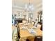 Elegant dining room with a chandelier, tray ceiling, and a table set for a formal meal at 5430 Lemoyne Sw Dr, Atlanta, GA 30331