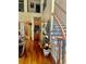 Elegant foyer featuring staircase with iron railings and hardwood floors, with a bar area at 5430 Lemoyne Sw Dr, Atlanta, GA 30331