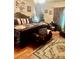 Spacious bedroom with hardwood floors, featuring elegant furniture and decor, with a decorative rug at 5430 Lemoyne Sw Dr, Atlanta, GA 30331