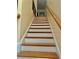 Wooden staircase with white risers and a light wood banister, leading to the upper level at 5430 Lemoyne Sw Dr, Atlanta, GA 30331