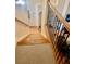 A staircase with wooden steps, a carpeted landing, and a railing leading to the next level of the home at 5430 Lemoyne Sw Dr, Atlanta, GA 30331