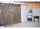 Basement featuring a rustic barn door adding character to the space, with metal ladder shelf at 6570 Canyon Cv, Cumming, GA 30028