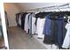 Organized walk-in closet with plenty of hanging space for clothes at 6570 Canyon Cv, Cumming, GA 30028