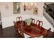 Formal dining room featuring hardwood floors, wainscoting, chandelier, and seating for six at 6570 Canyon Cv, Cumming, GA 30028