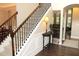 Spacious entryway with staircase, hardwood floors, and tasteful decor, showcasing an inviting atmosphere at 6570 Canyon Cv, Cumming, GA 30028