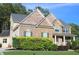Charming two-story home featuring brick and stone accents, complemented by a well-maintained lawn and garden at 6570 Canyon Cv, Cumming, GA 30028