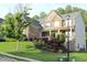 Beautiful two-story home features a stone and siding exterior, covered porch, and landscaped front yard at 6570 Canyon Cv, Cumming, GA 30028