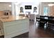 Spacious kitchen with an island, granite countertops, and an open view of the living area at 6570 Canyon Cv, Cumming, GA 30028