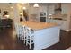 Bright kitchen with a large island, granite countertops, stainless steel appliances, and white cabinets at 6570 Canyon Cv, Cumming, GA 30028