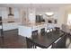 Large, open kitchen with stainless appliances, granite countertops, and dining area at 6570 Canyon Cv, Cumming, GA 30028
