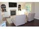Comfortable seating area with fireplace and natural light from the large window at 6570 Canyon Cv, Cumming, GA 30028