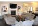 Inviting living room featuring a fireplace, built-in bookshelves, and comfortable seating at 6570 Canyon Cv, Cumming, GA 30028