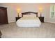Spacious main bedroom featuring a large bed, two nightstands, and an armoire at 6570 Canyon Cv, Cumming, GA 30028