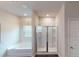 Bright bathroom with separate tub and glass enclosed shower at 1278 Hollingsworth Way, Dacula, GA 30019