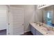 Bathroom featuring double sinks with modern faucets, spacious counter tops and a large mirror at 1278 Hollingsworth Way, Dacula, GA 30019