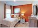 Cozy bedroom featuring an orange accent wall at 1278 Hollingsworth Way, Dacula, GA 30019