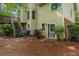 View of the home's backyard, featuring a patio area and lush greenery at 134 Waterloch Ct, Lawrenceville, GA 30043