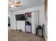 Bedroom features a TV, ceiling fan, and a closet with a sliding door at 134 Waterloch Ct, Lawrenceville, GA 30043