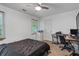 Bedroom features a ceiling fan, a window, and a desk with chair at 134 Waterloch Ct, Lawrenceville, GA 30043